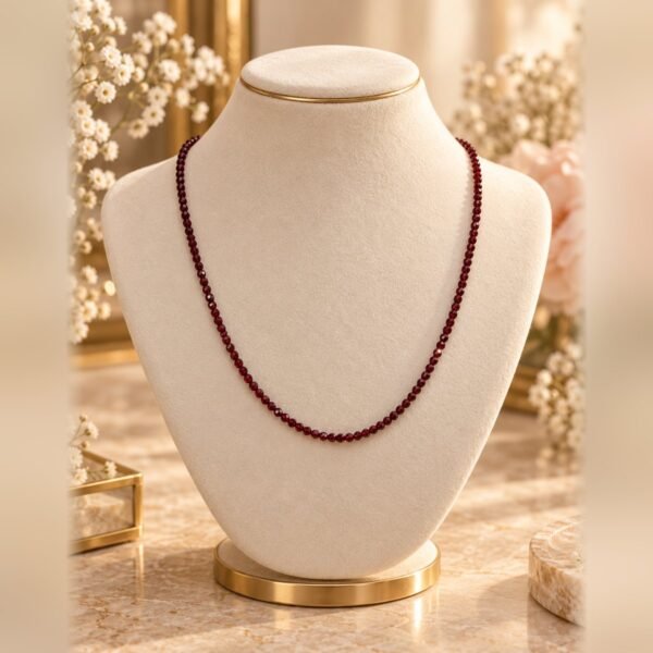 collier garance fine pierres rouges facettees buste Collier GARANCE FINE en pierres rouges naturelles facettées de 2 mm, rouge bordeaux, porté sur buste crème – Serinaé